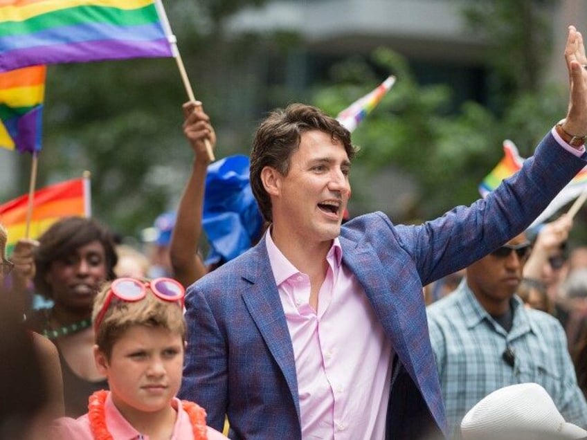 Prime Minister Justin Trudeau waves to the crowd as he marches in the Pride Parade in Toronto, June 25, 2017. ( GEOFF ROBINS/AFP via Getty)