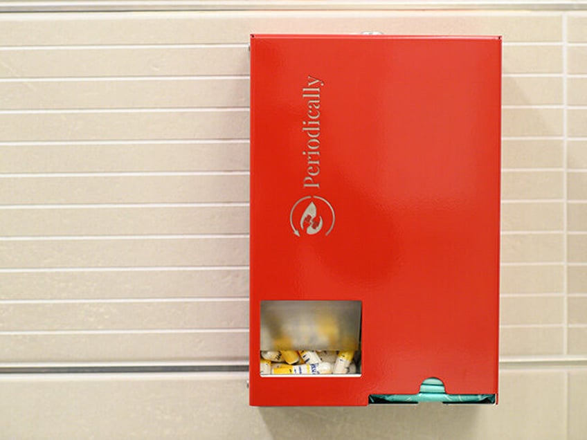 A tampon and sanitary pad dispenser from "Periodically" hangs in the ladies&#039