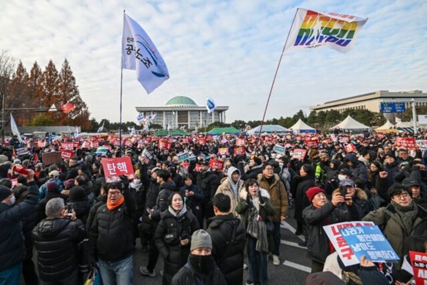 South Korean protesters mass outside the National Assembly in Seoul ahead of a vote to imp