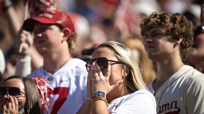 Alabama fans react during a game