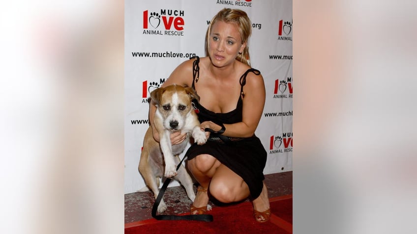 Kaley Cuoco holding a dog