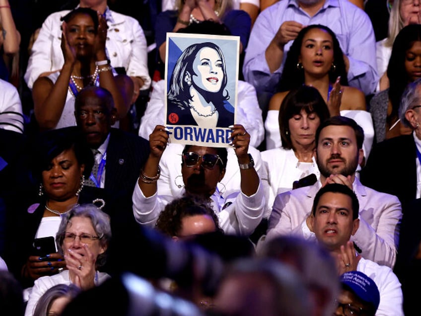 An attendee holds a poster of Democratic presidential candidate, U.S. Vice President Kamal