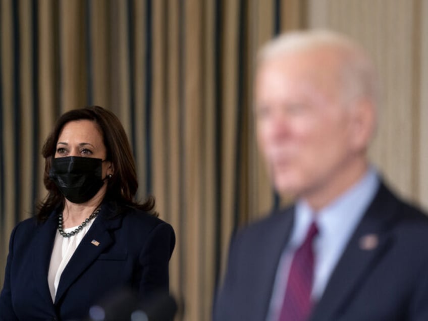 U.S. Vice President Kamala Harris, left, wears a protective mask as U.S. President Joe Bid