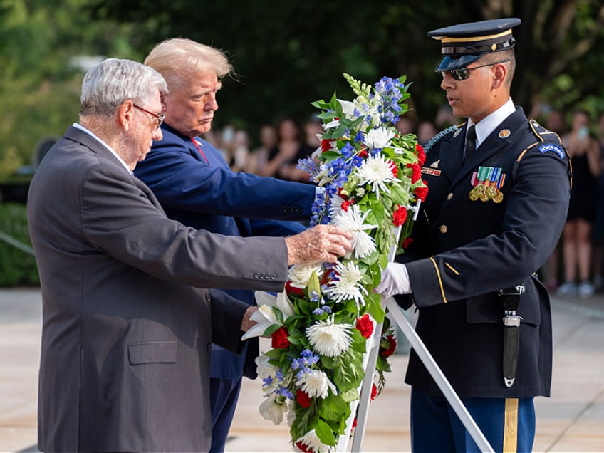 Bill Barnett, left, grandfather of Darin Taylor Hoover, and Republican presidential nominee former President Donald Trump place a wreath at the Tomb of the Unknown Solider in honor of Staff Sgt. Darin Taylor Hoover at Arlington National Cemetery, Monday, Aug. 26, 2024, in Arlington, Va. (AP Photo/Alex Brandon)