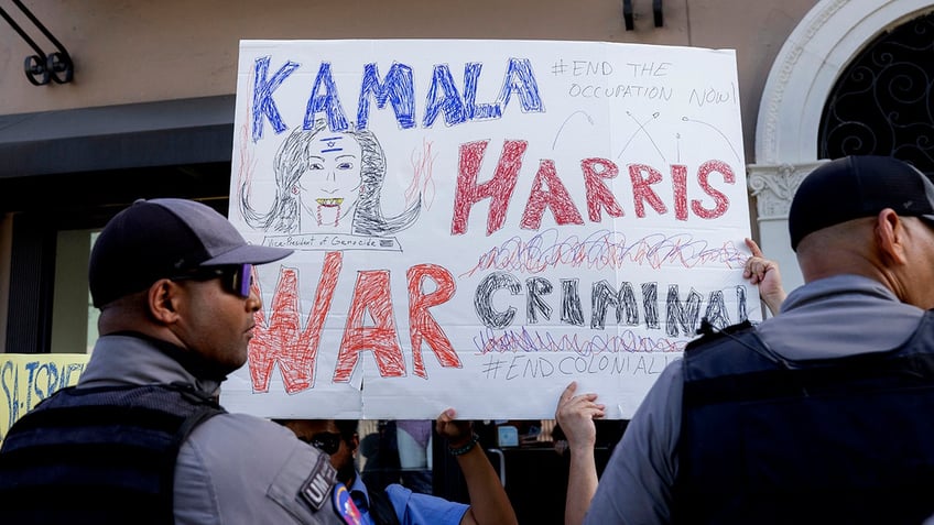 Kamala Harris is a war criminal sign in San Juan