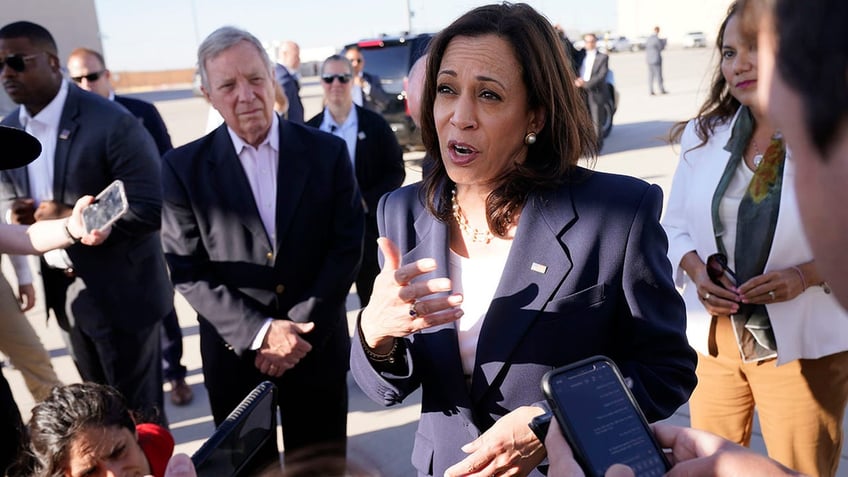 Kamala Harris uses hand gestures as she talks to the press