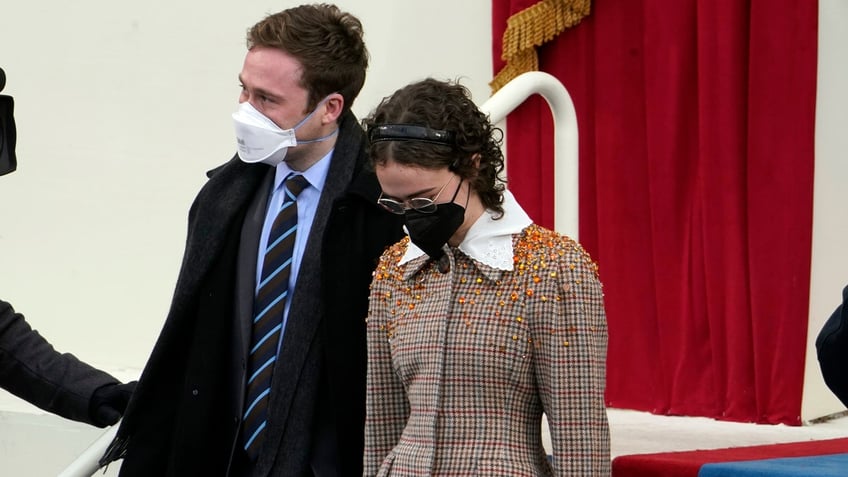 Cole and Ella Emhoff arrive during the 59th Presidential Inauguration at the U.S. Capitol in Washington, Wednesday, Jan. 20, 2021. (AP Photo/Andrew Harnik)