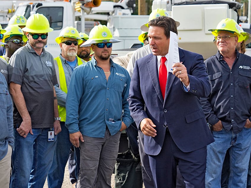 Florida Gov. Ron DeSantis, second from right, speaks to linemen before a news conference, Wednesday, Sept. 25, 2024, at the Tampa Electric Company offices in Tampa, Fla., as Tropical Storm Helene, expected to become a hurricane, moves north along Mexico’s coast toward the U.S. (AP Photo/Chris O'Meara)