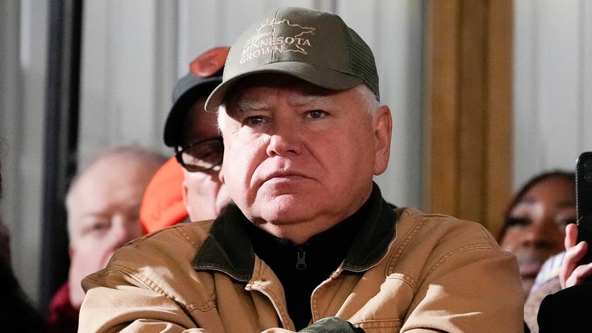 Minnesota Gov. Tim Walz listens as President Joe Biden speaks