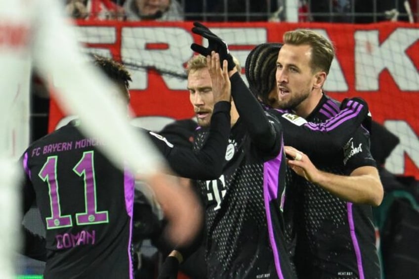 kane extends scoring run as bayern ease past cologne