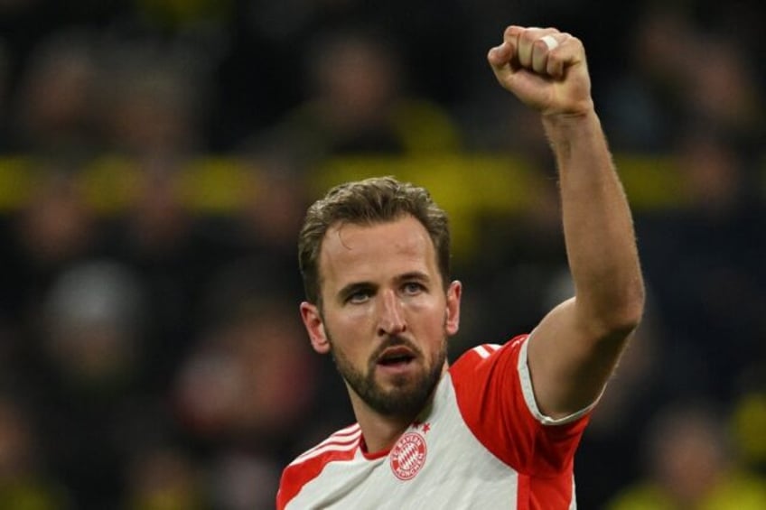 kane hits hat trick as bayern thump dortmund to keep pace with leaders leverkusen