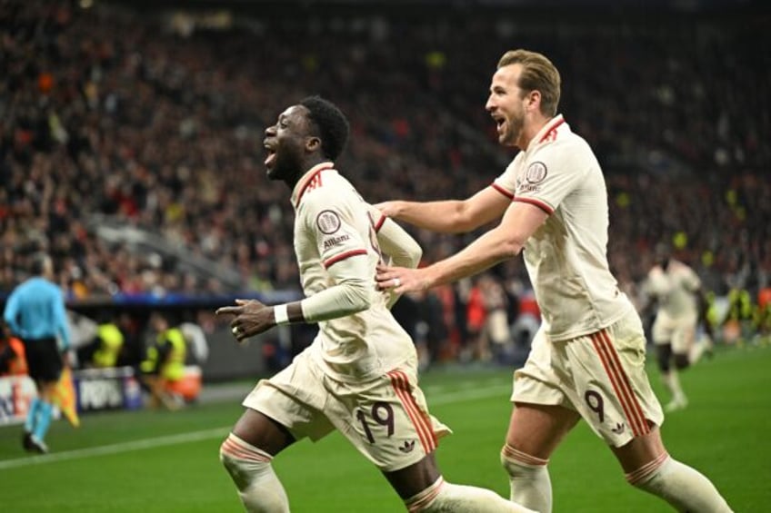 Bayern Munich striker Harry Kane (R) celebrates with winger Alphonso Davies on Tuesday