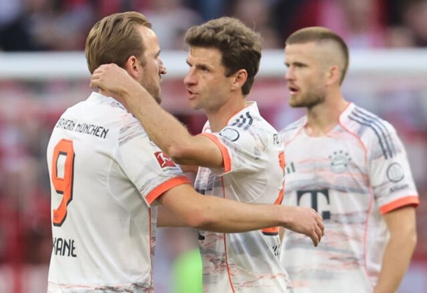 Bayern Munich's Harry Kane (L) farewells departing veteran Thomas Mueller (middle). Eric D