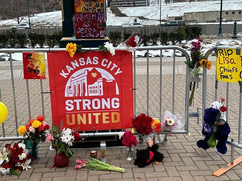 Flowers, signs and other items are gathered in front of Union Station on Friday, Feb. 16,