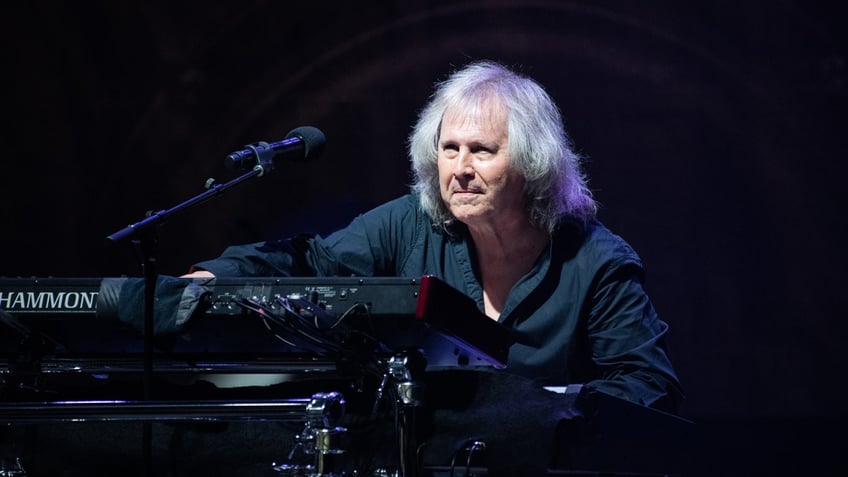 Ronnie Platt sits at a piano