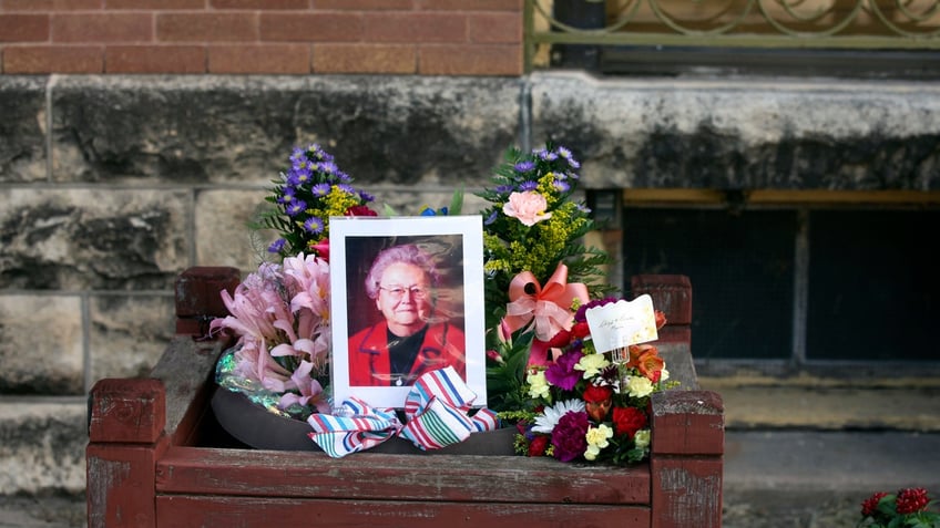 A photo of a portrait of Marion County Record co-owner Joan Meyer surrounded by flowers and ribbons