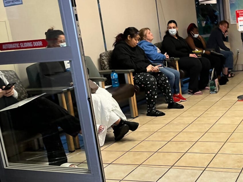 Patients fill out a row of chairs while waiting to be seen at the emergency room at Saint