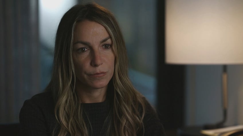 A close-up of Karen Read looking serious in a black sweater