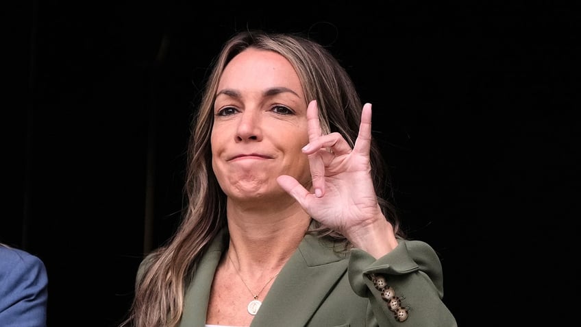Karen Read signs to fans as she exits court