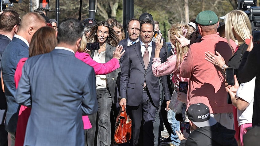 Karen Read and her lawyer Alan Jackson pass through a gauntlet of supporters en route to Norfolk Superior Court