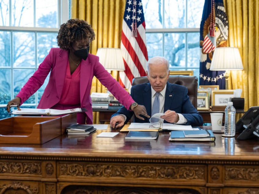 President Joe Biden confers with Press Secretary Karine Jean-Pierre during a daily press m