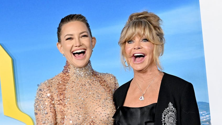 Goldie Hawn and Kate Hudson laugh while on red carpet at movie premiere