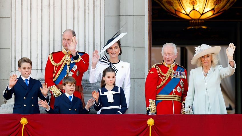The British royal family standing together at the Buckingham Palace balcony.