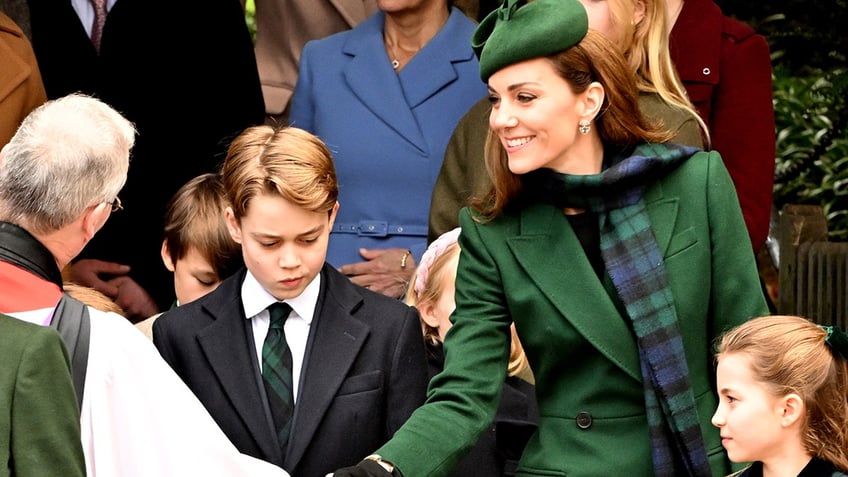 Kate Middleton greeting a priest as she stands in between Prince George and Princess Charlotte