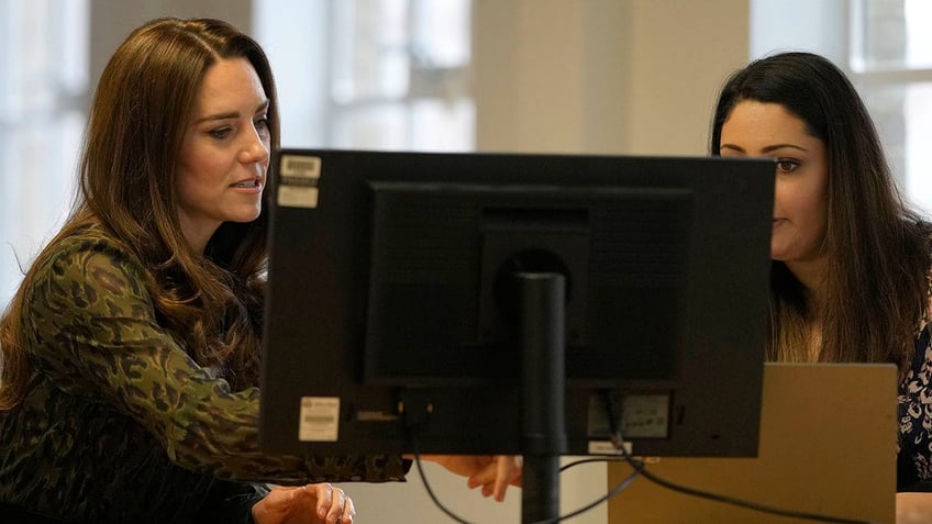 Kate Middleton and a woman looking at a computer screen