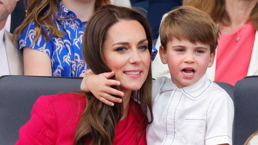 Prince Louis with his arm around Kate Middleton's neck