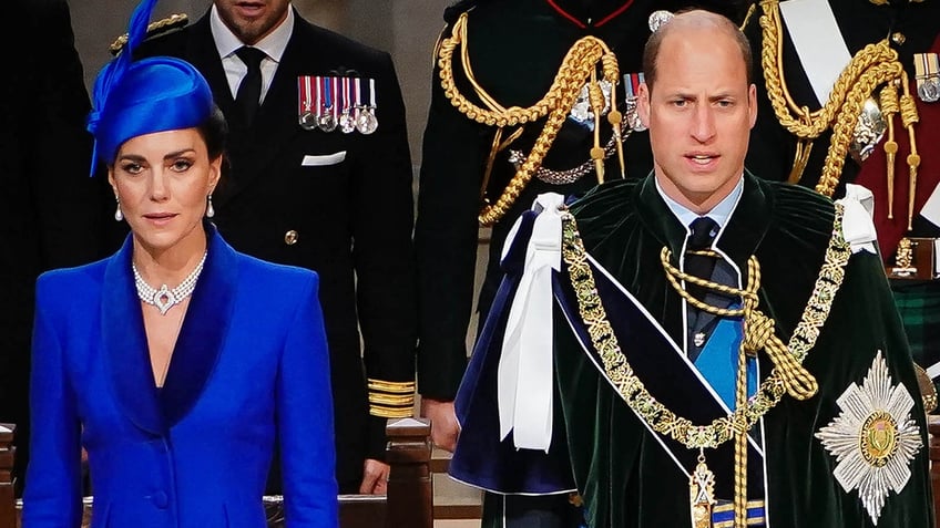 Kate Middleton in a bright blue coat dress standing next to Prince William in royal regalia.