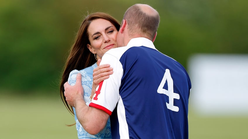 Prince William giving Kate Middleton a kiss on the cheek during a polo match.