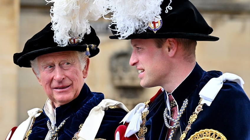 King Charles sitting next to Prince William wearing matching royal regalia.