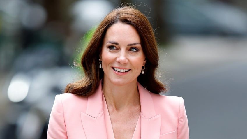 A close-up of Kate Middleton wearing a peach blazer
