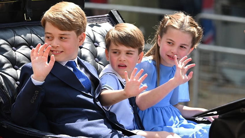 The royal children in a carriage waving