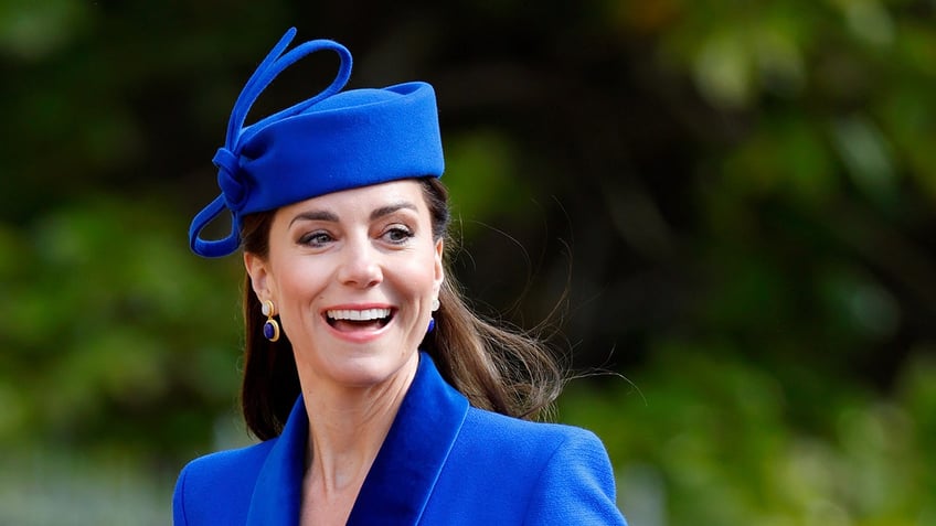 Kate Middleton wearing a blue suit with a matching hat