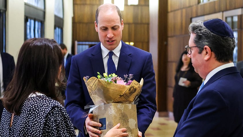 Prince William receiving flowers