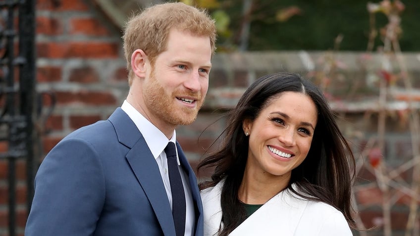 Prince Harry and Meghan Markle smile as senior royals