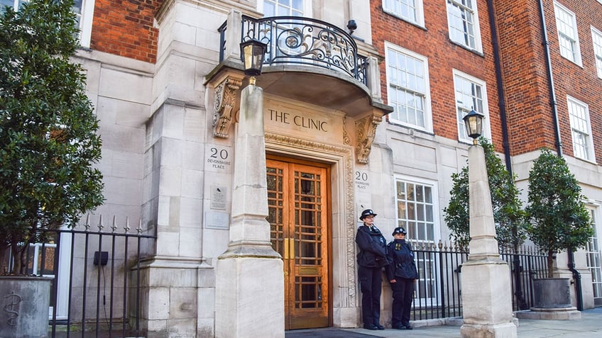 Two policemen standing in front of The London Clinic