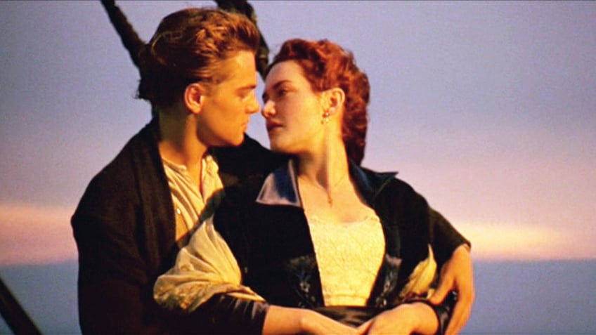 Kate Winslet looks back at Leonardo DiCaprio in character as Rose and Jack on the boat during a scene from the "Titanic."