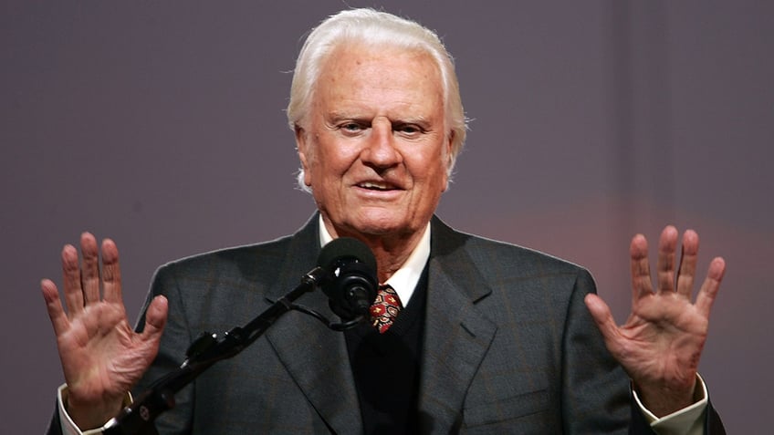 Rev. Billy Graham speaking at a podium