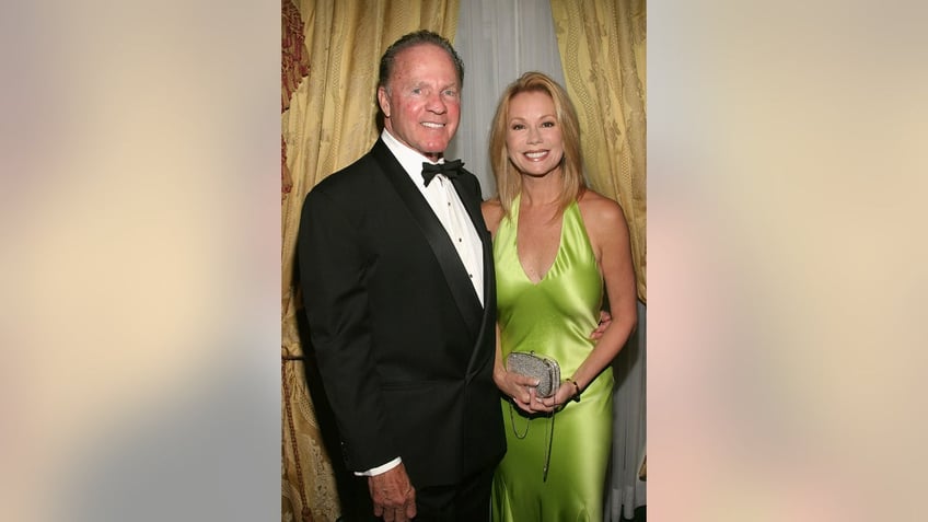 Kathie Lee Gifford wearing a satin yellow-green dress with Frank Gifford wearing a tuxedo.