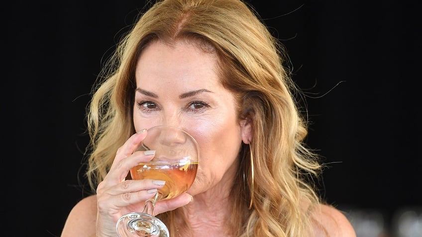 Kathie Lee Gifford drinking a glass of wine