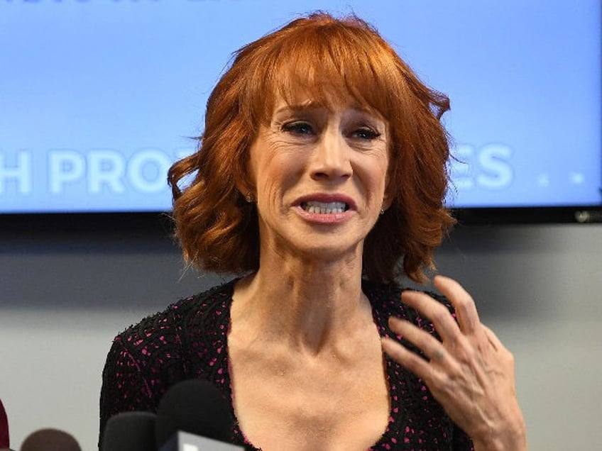 Comedian Kathy Griffin (R) reacts during a news conference to discuss the comedian's