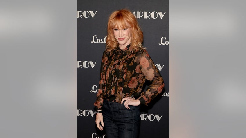 A close-up of Kathy Griggin wearing a black floral blouse