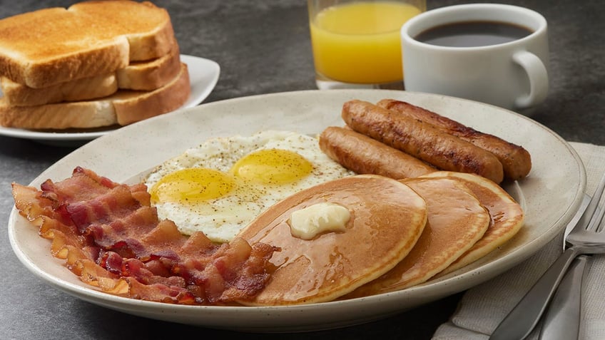 Breakfast with Pancakes, Bacon, Sausages Sunny Side up Eggs and Toast