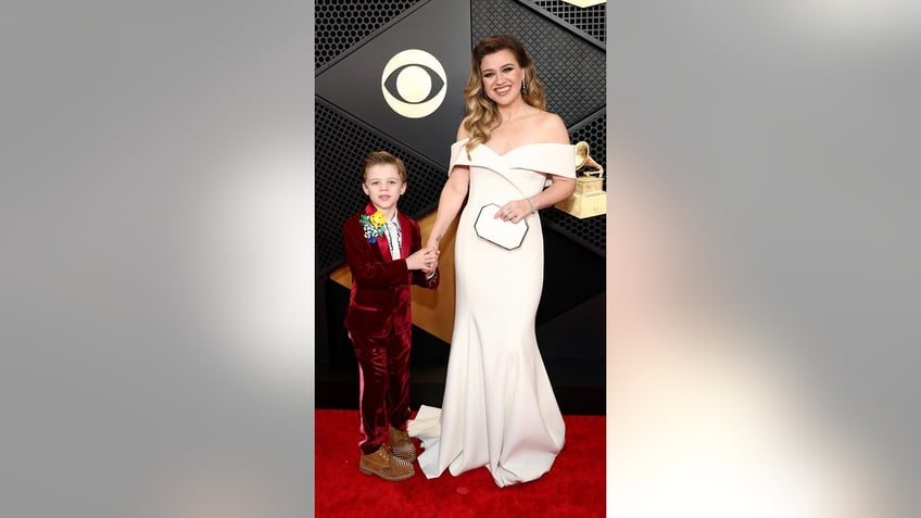 Remington Alexander and Kelly Clarkson attends the 66th GRAMMY Awards