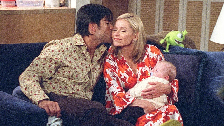 Mark Consuelos kissing Kelly Ripa on cheek during episode of "All My Children"