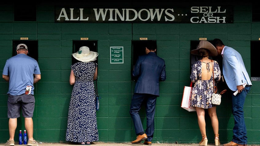 Horse racegoers place bets