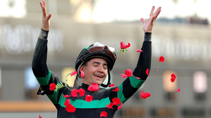 Jockey Brian J. Hernandez Jr. celebrates winning the Derby